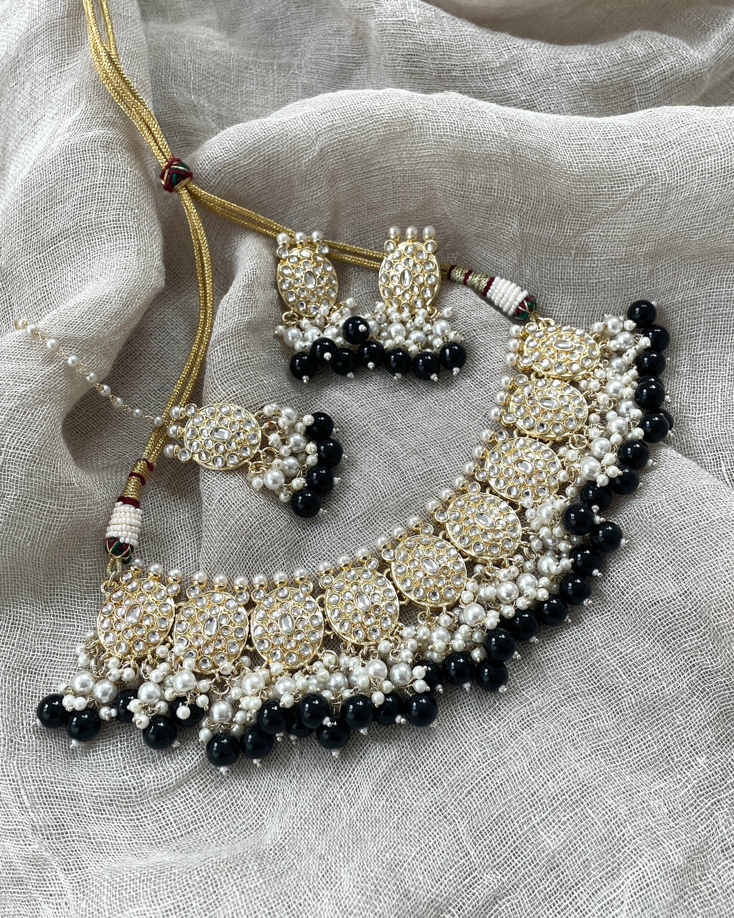 Gold-colored jewelry set with black details
