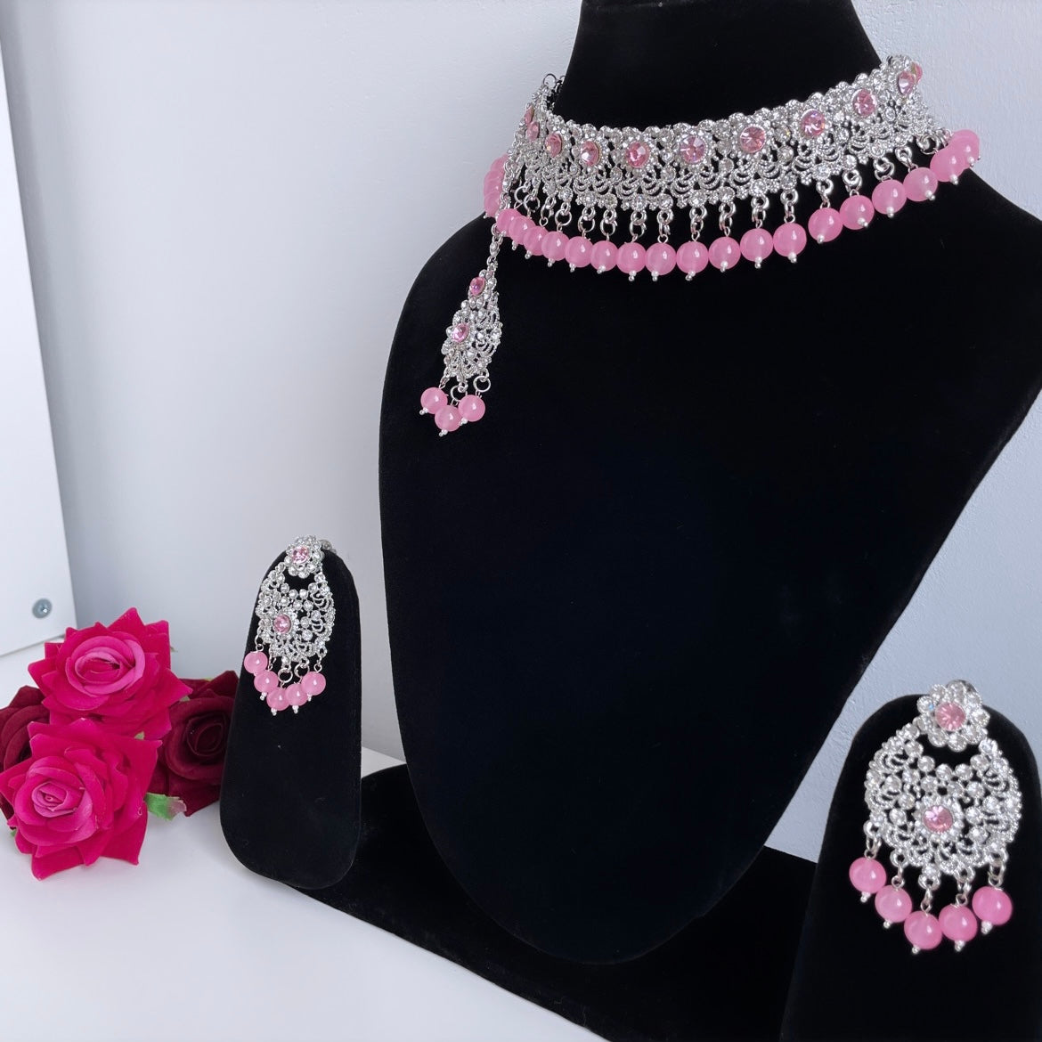 Silver colored set with pink stones