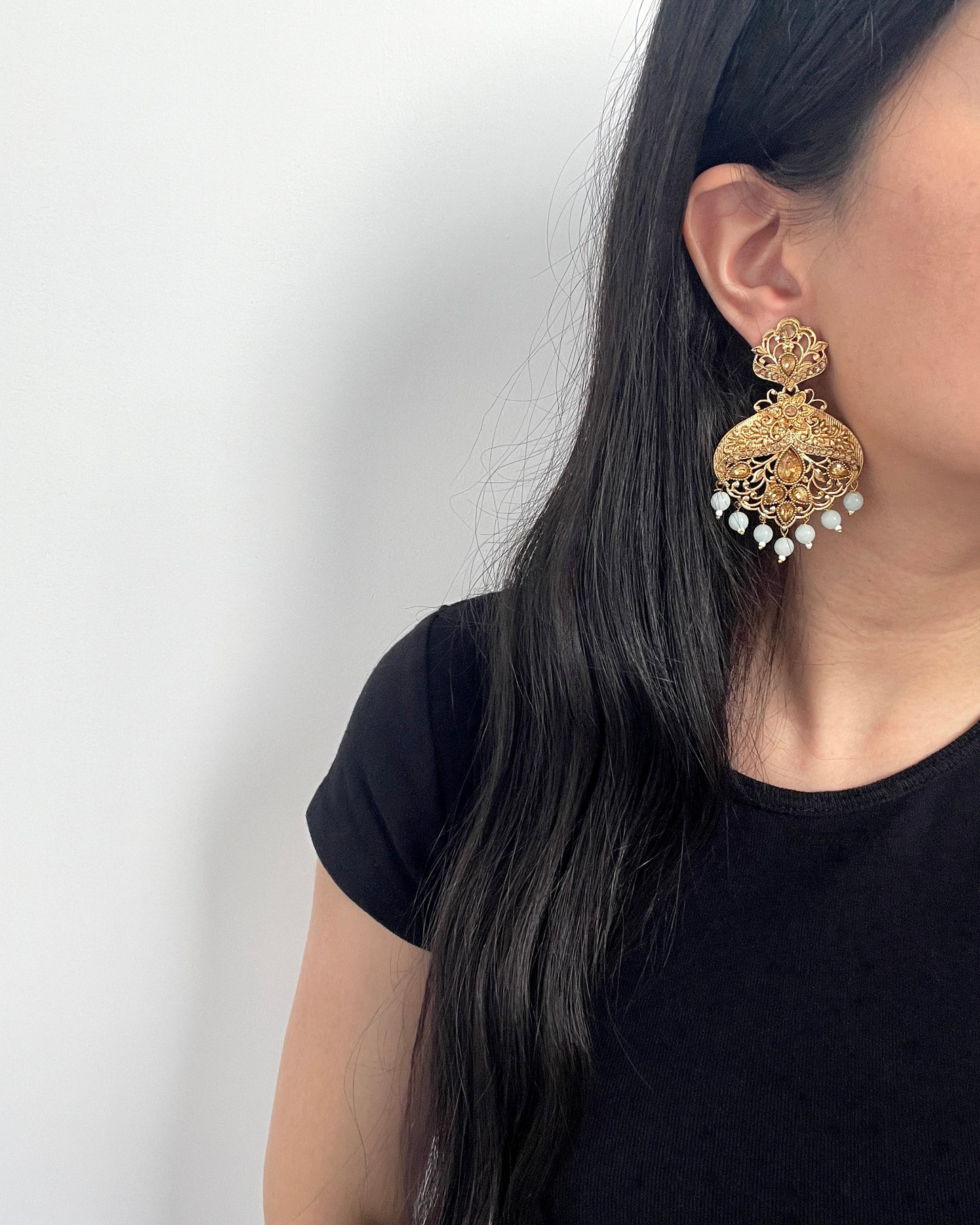 Goudkleurige oorbellen met lichtgrijze kralen