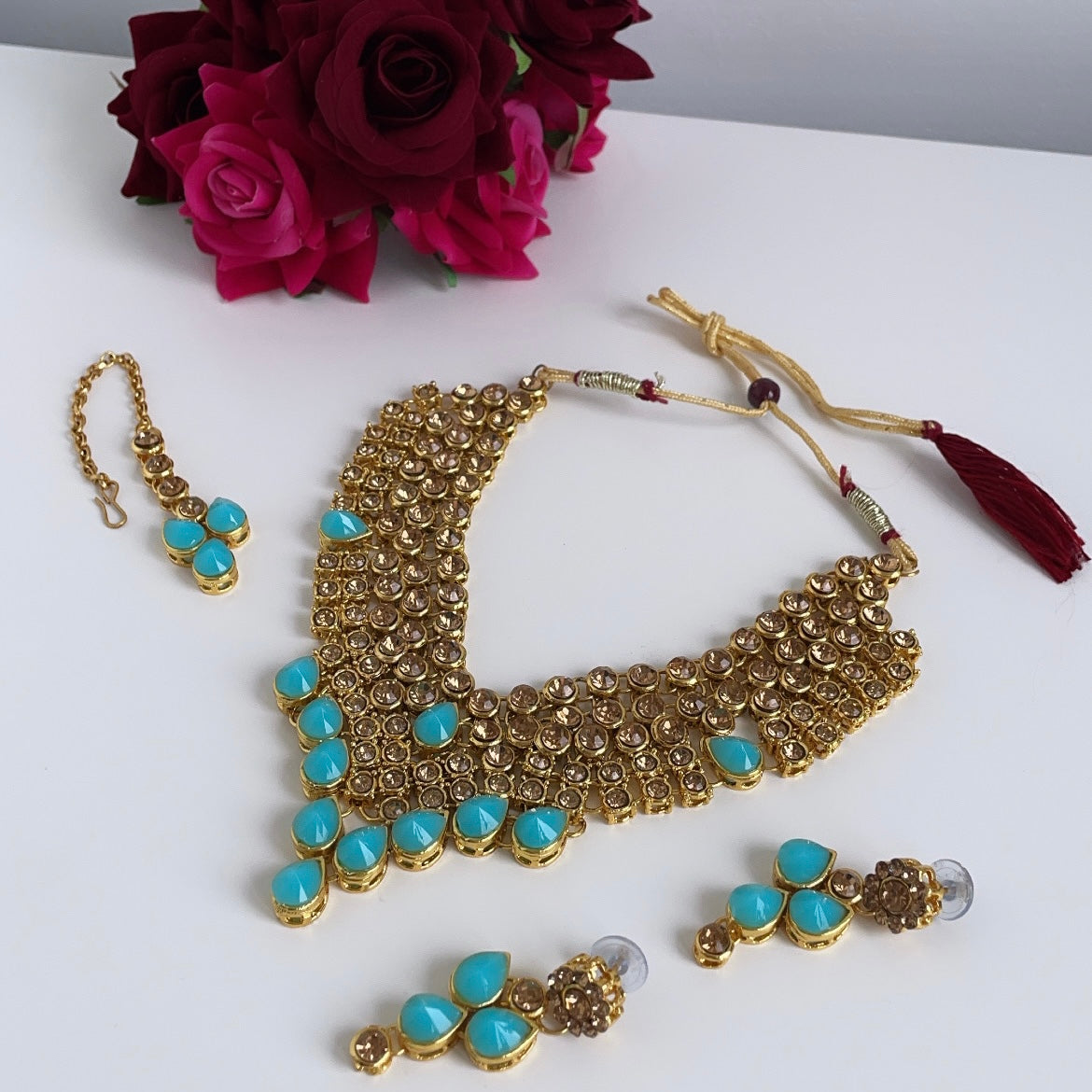 Gold-colored jewelry set with light blue stones
