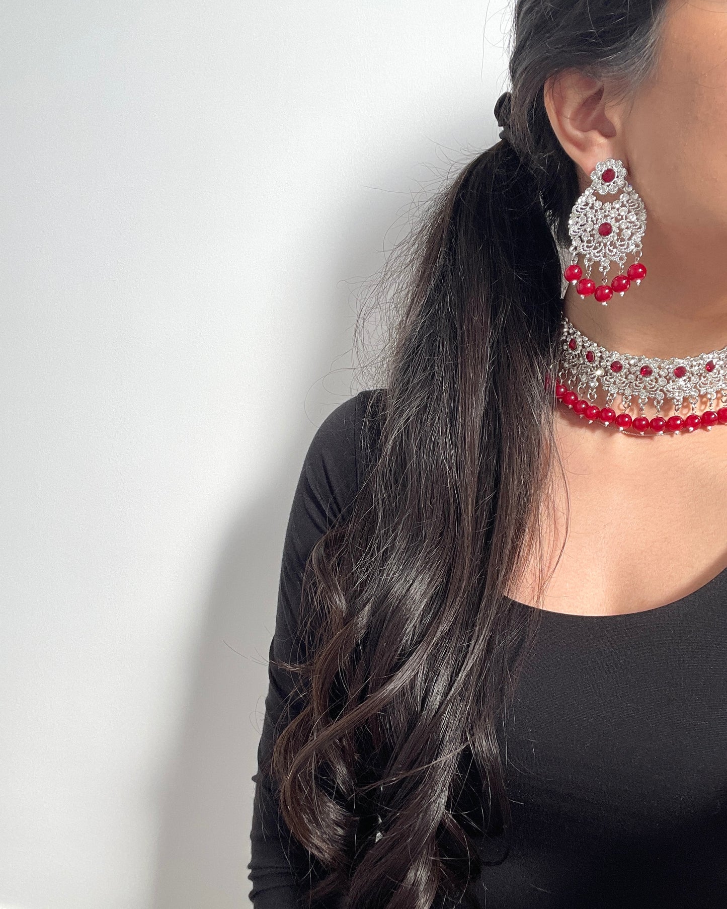 Silver-colored jewelry set with red details