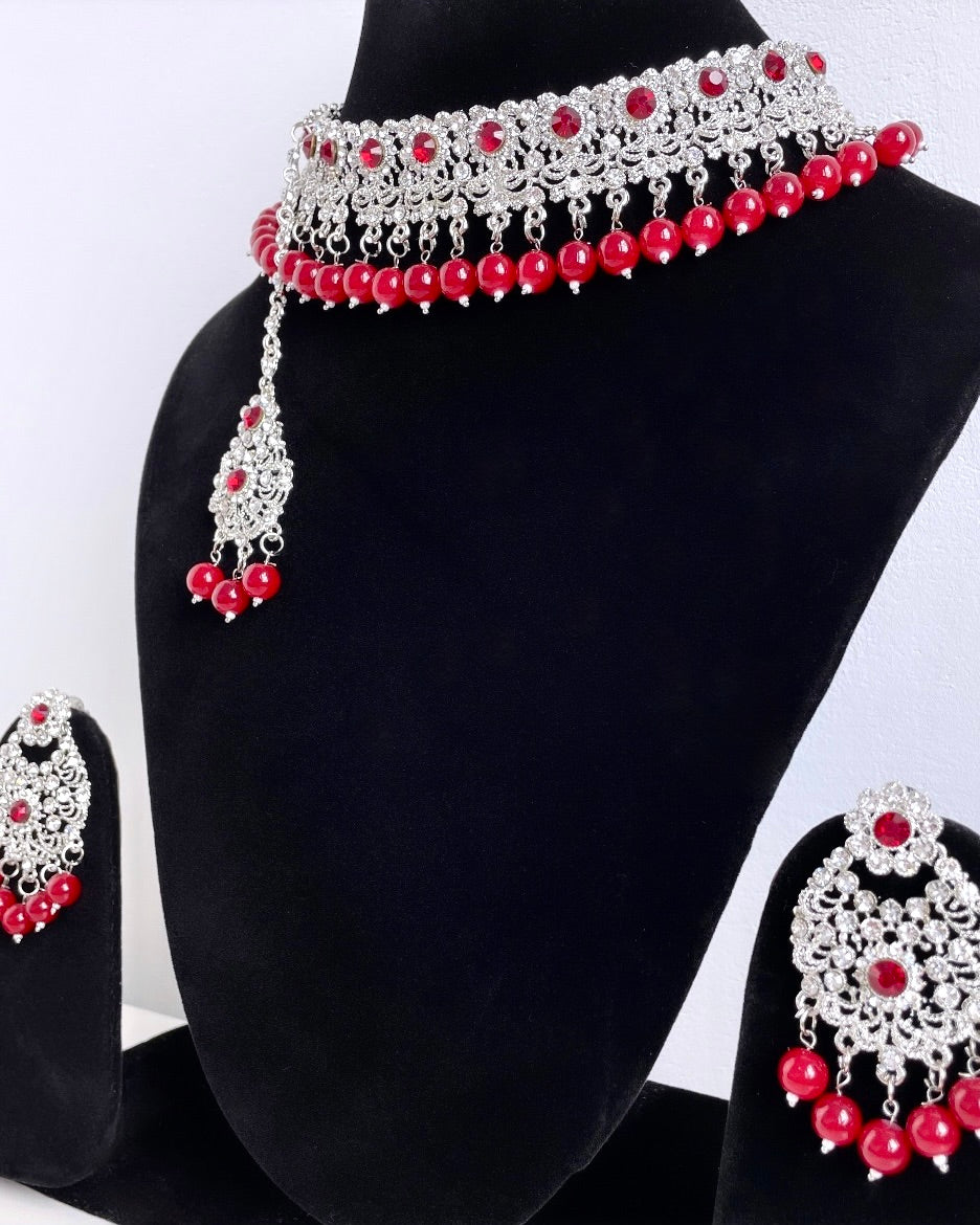Silver-colored jewelry set with red details