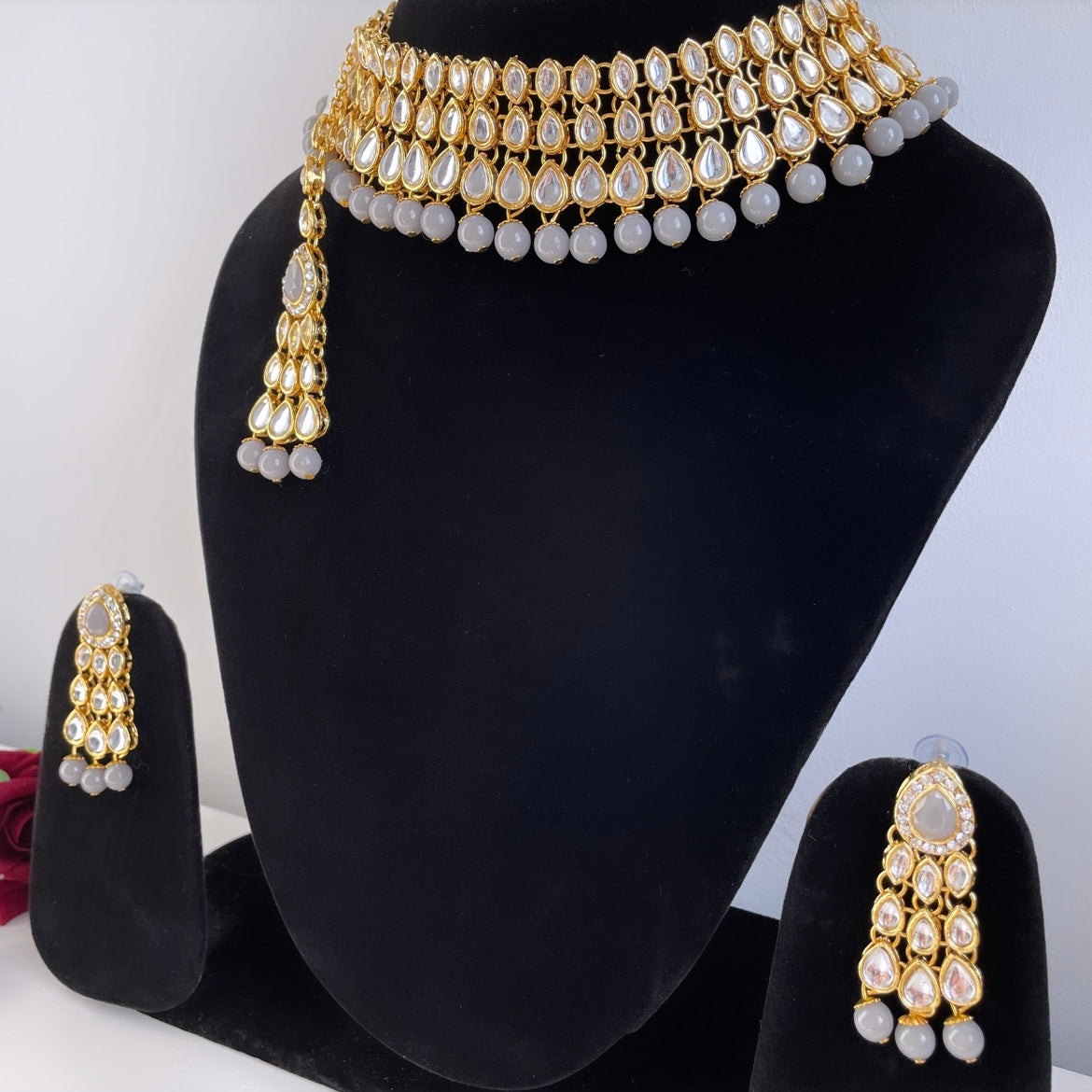 Gold-colored jewelry set with gray beads