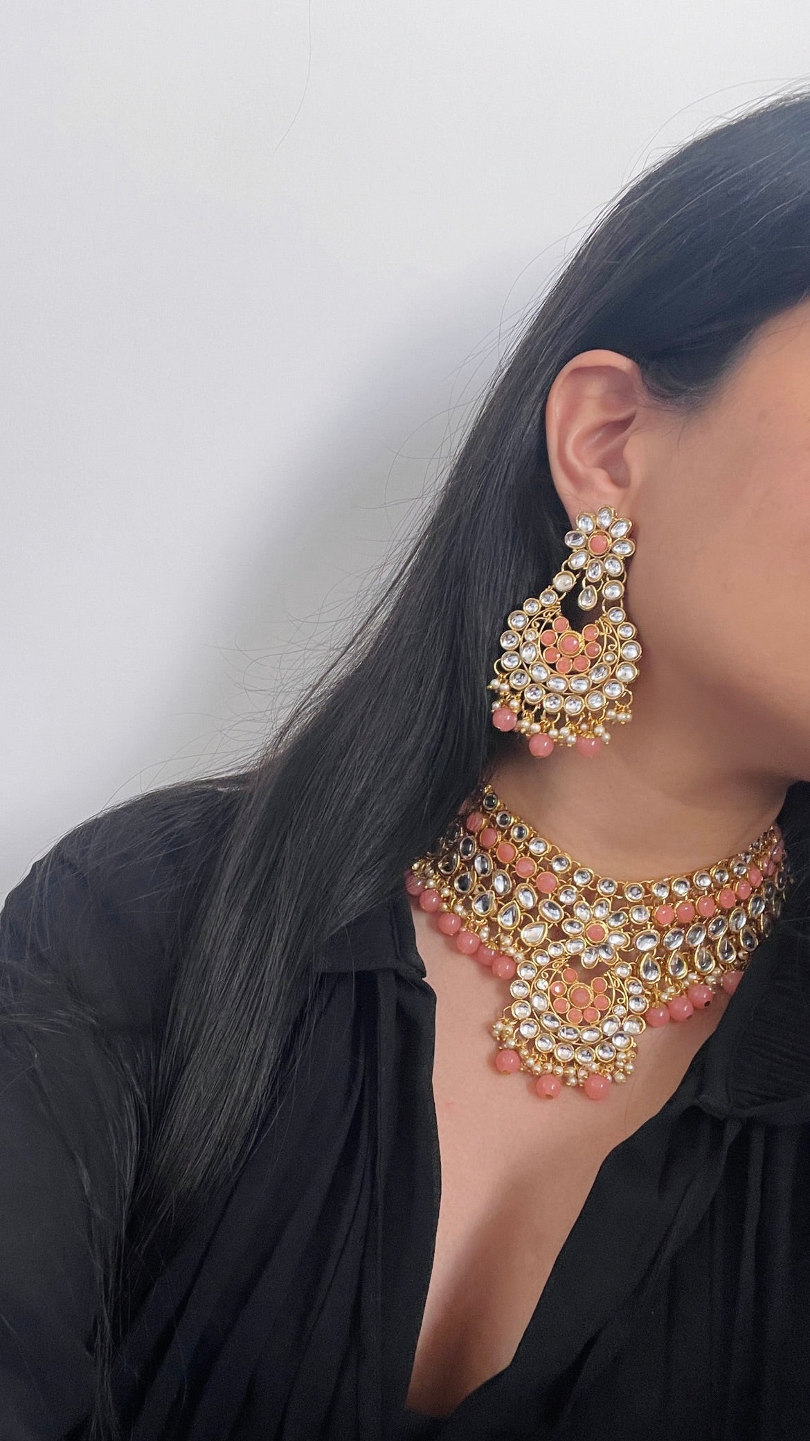 Gold-colored jewelry set with pink stones