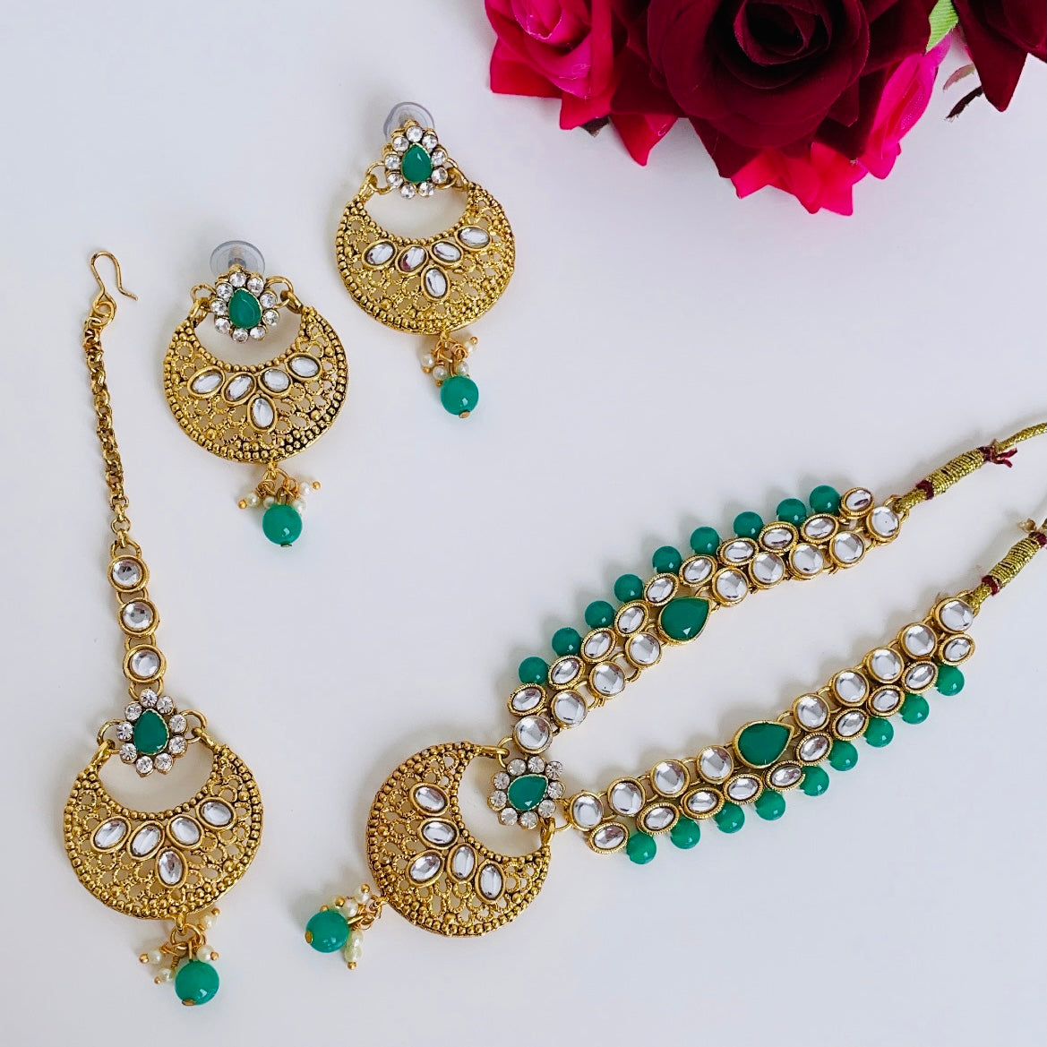 Gold-colored jewelry set with green stones