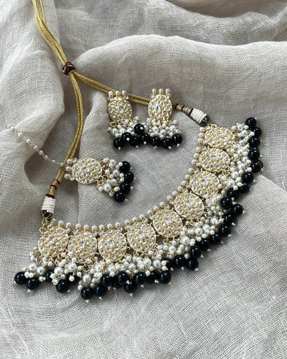 Gold-colored jewelry set with black details