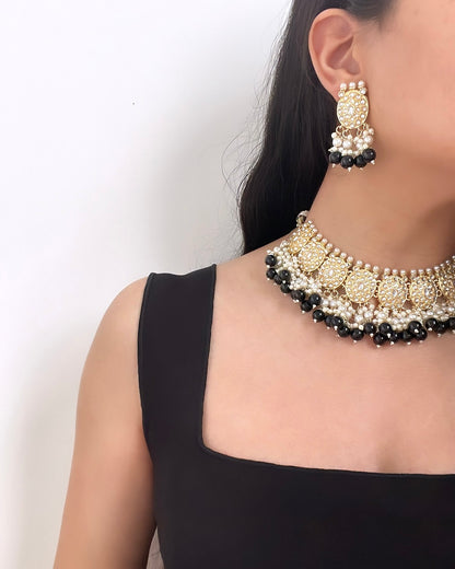 Gold-colored jewelry set with black details