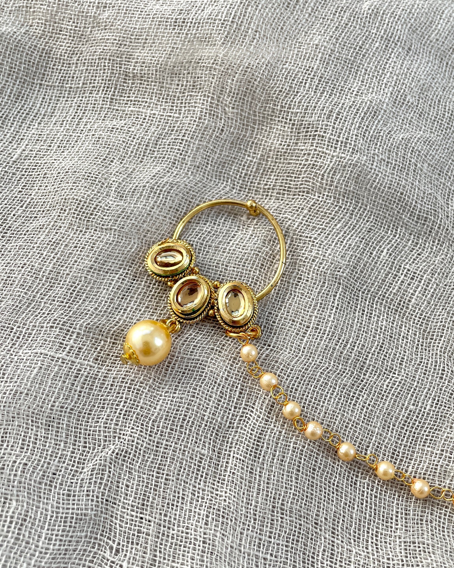 Gold colored nose ring