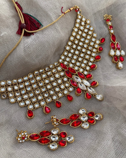 Gold-colored jewelry set with red crystal stones